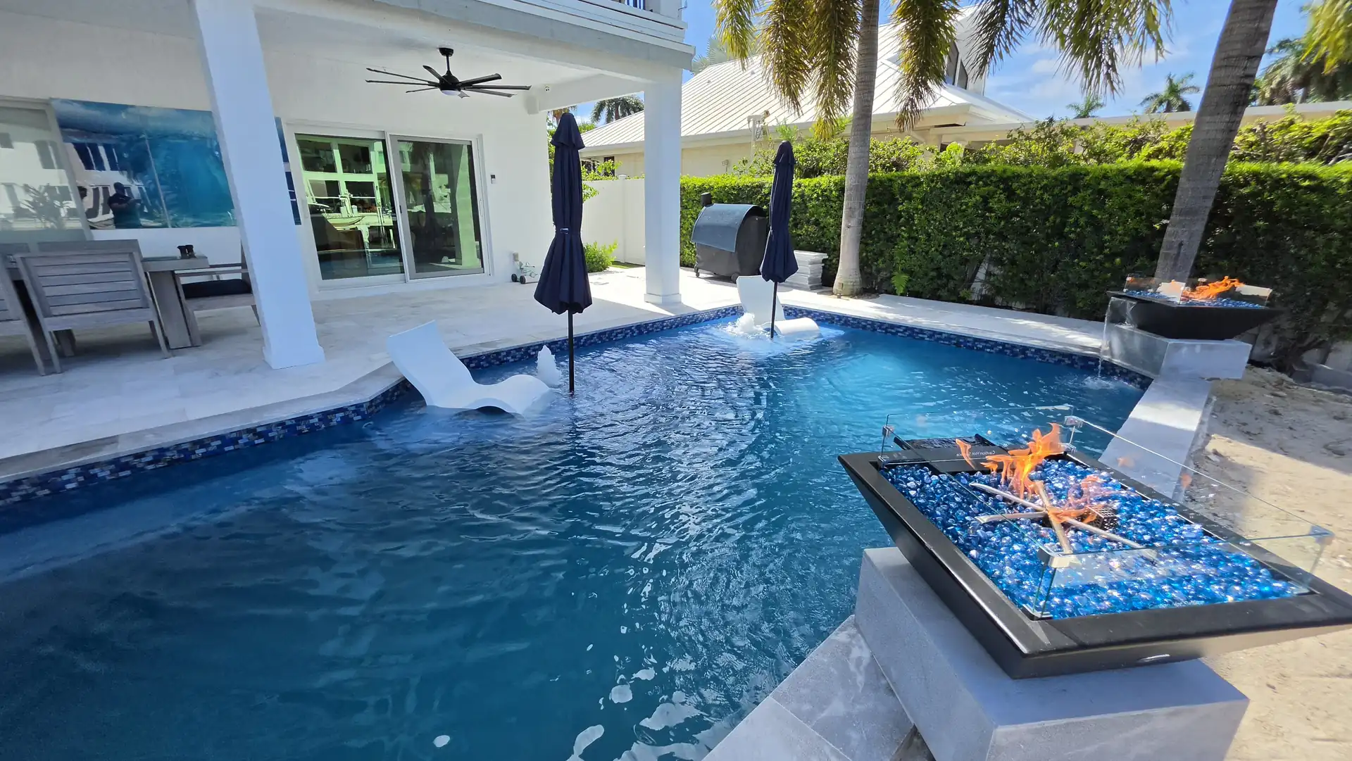 Waterfront pool with fire bowls on a Fort Lauderdale canal
